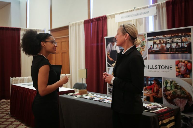 HTM student talking with Mackenzie Muller of Hillstone Restaurant Group
