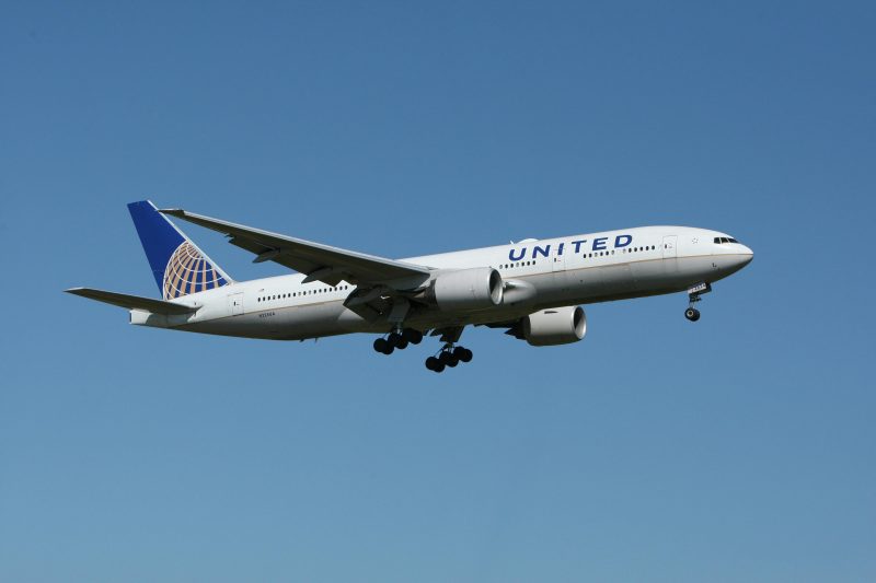 A united airlines airplane flying in the air.