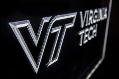 A silver Virginia Tech logo on a black background.